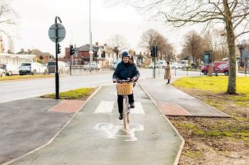 woman on a bicycle using one of the new cycle lanes in Hull