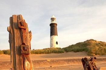 beach scene with a lighthouse