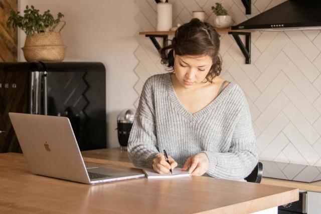 woman holding a baby at a laptop