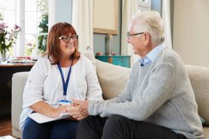 A female care worker helping and older man