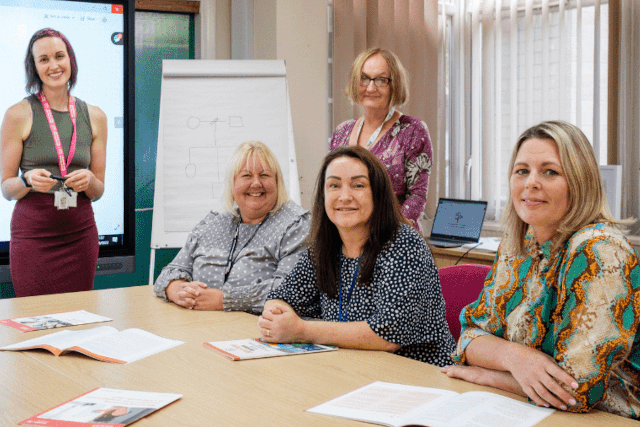 5 women around a table