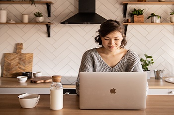 Woman applying for a job at home using a laptop